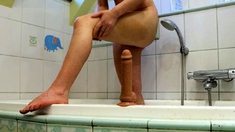 Redhead babe cums with her favorite toy after a shower.